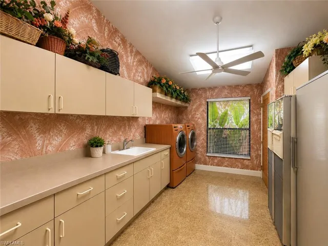 Digitally enhanced, Utility room with a Washer/Dryer and subzero appliances.
