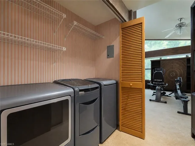 Digitally enhanced, Laundry area with Washer/Dryer in the primary bedroom wing.