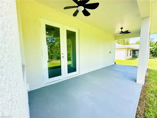 View of patio with a ceiling fan and french doors