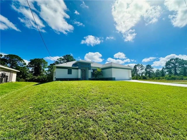 View of front of house featuring an attached garage, a front yard, and concrete driveway