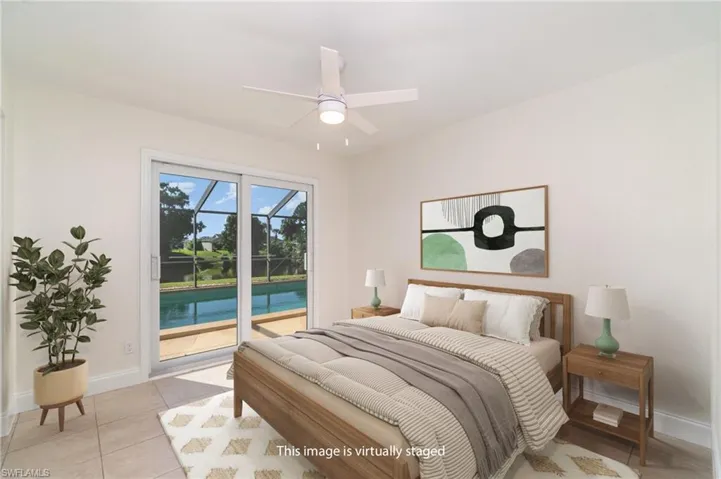 Bedroom featuring light tile patterned floors, access to exterior, and ceiling fan