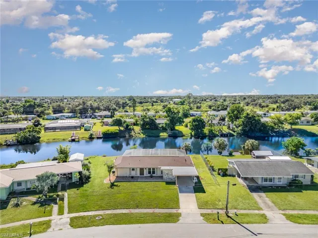 Aerial perspective of suburban area featuring a nearby body of water