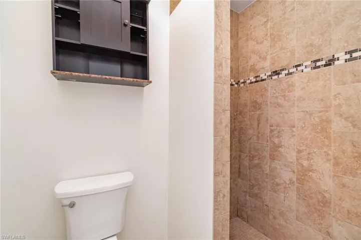 Full bath with a shower stall and toilet