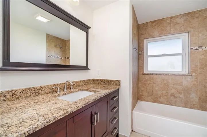 Full bath featuring vanity and tub / shower combination