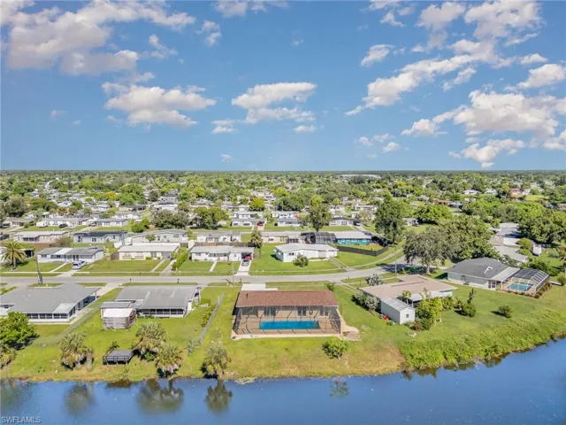Aerial perspective of suburban area with a nearby body of water