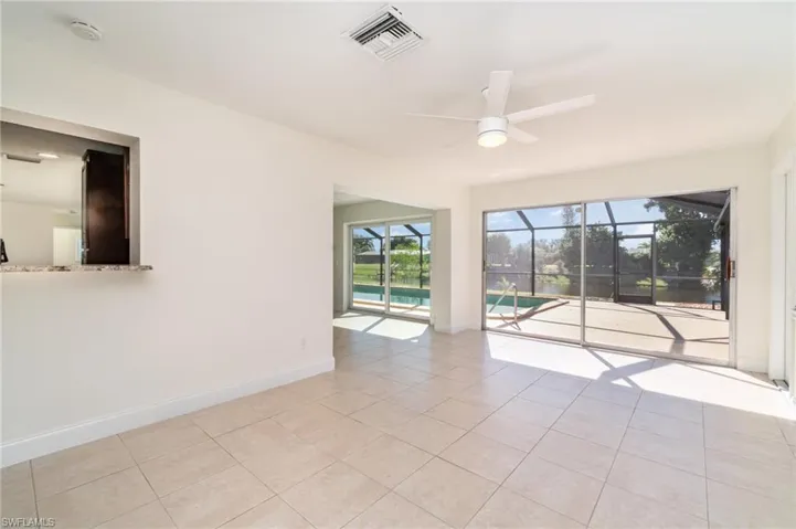 Spare room with a sunroom, light tile patterned floors, and ceiling fan