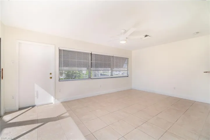 Spare room featuring light tile patterned flooring and a ceiling fan