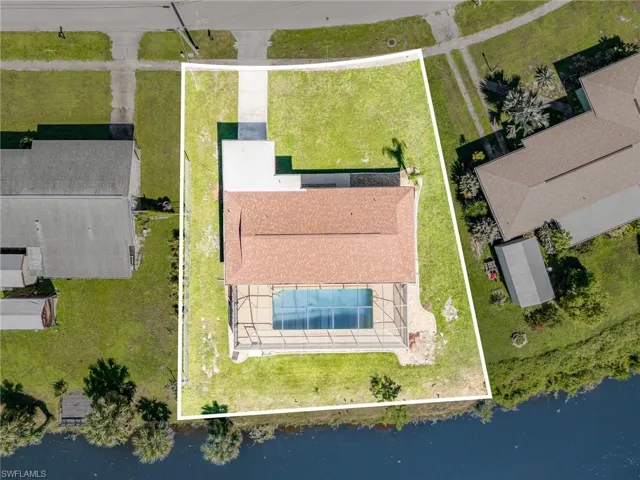 Aerial view of property and surrounding area with property parcel outlined