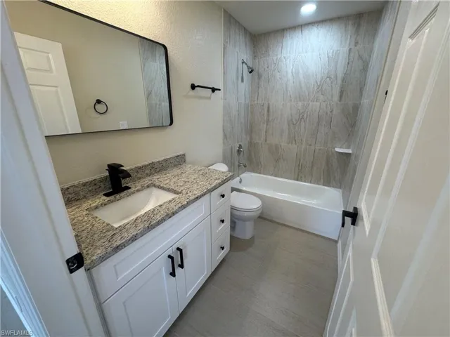 Guest Bathroom featuring newly tiled shower