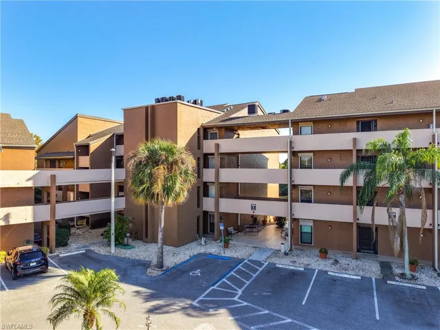 View of property featuring uncovered parking