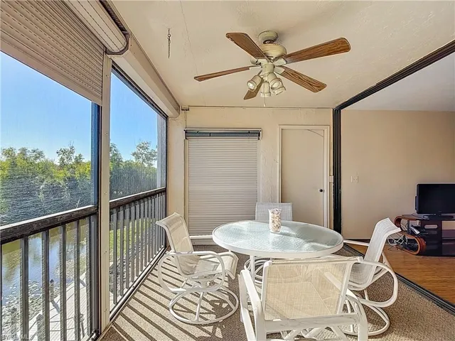 Sunroom / solarium featuring a ceiling fan, outdoor dining space, and a balcony