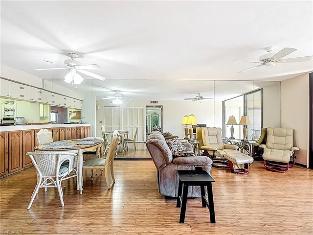 Living room featuring light wood-style flooring and a ceiling fan
