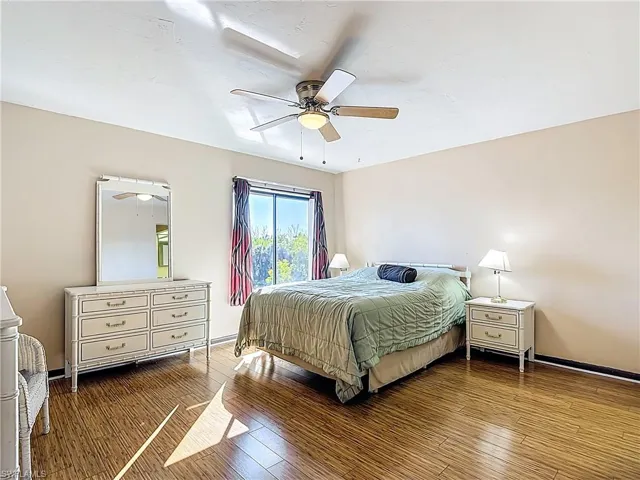Bedroom featuring wood-type flooring and a ceiling fan