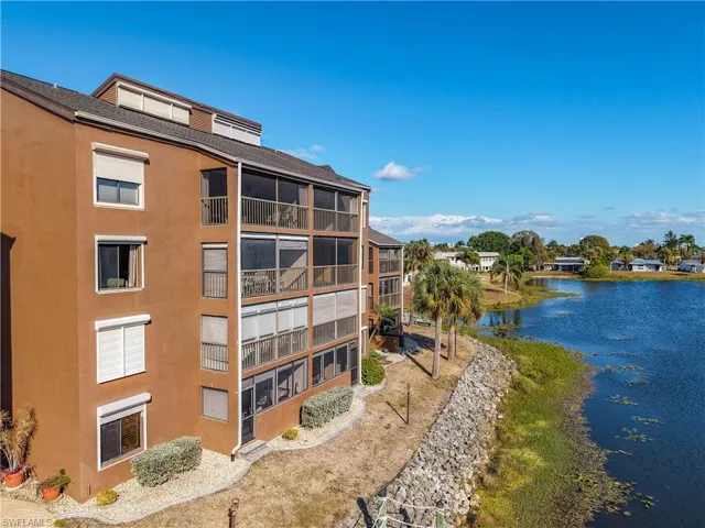 View of apartment building / complex featuring a water view