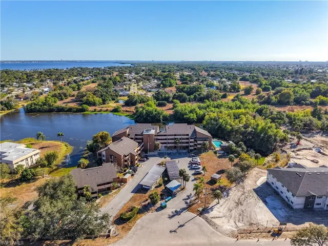 Aerial perspective of suburban area featuring a nearby body of water