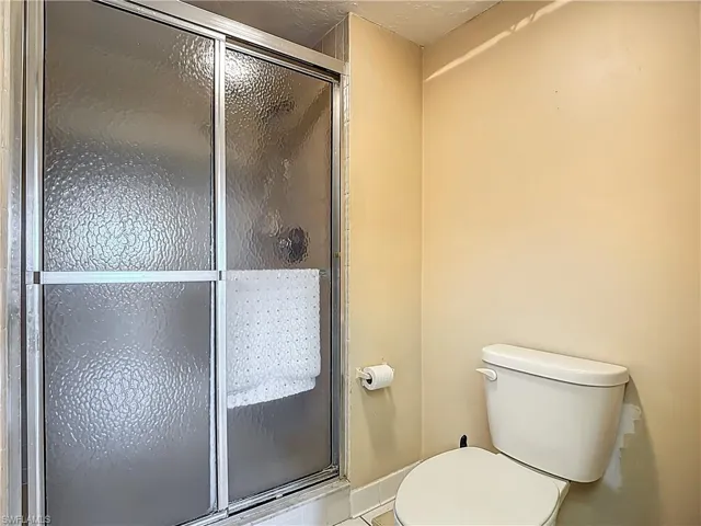 Bathroom with toilet and a stall shower