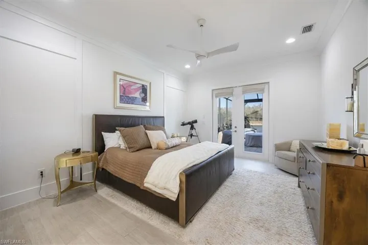 The very spacious primary bedroom has French doors that open to the pool deck