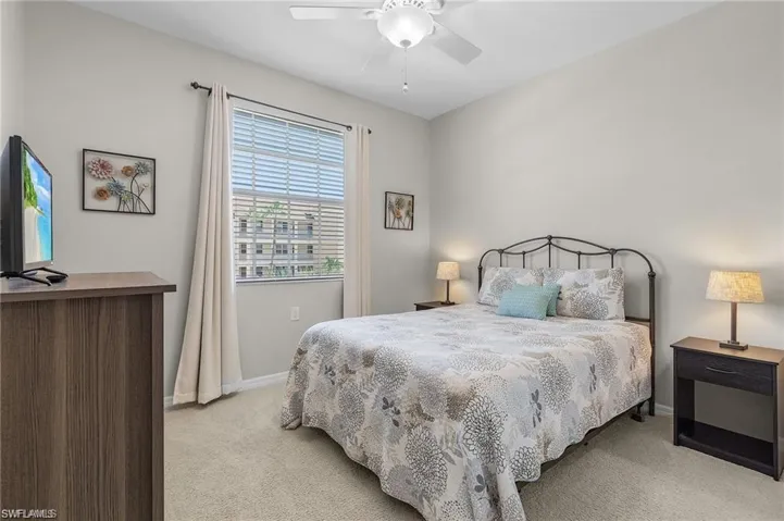Carpeted bedroom with ceiling fan
