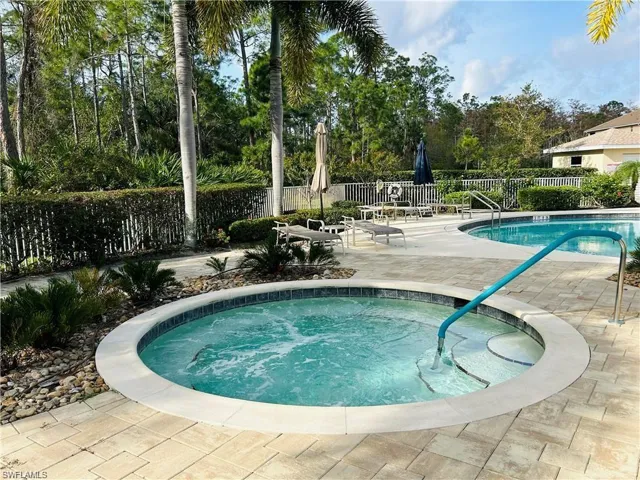 View of pool with a community hot tub and a patio