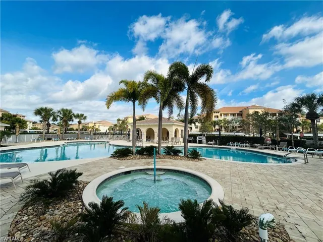View of swimming pool with a patio area and a community hot tub