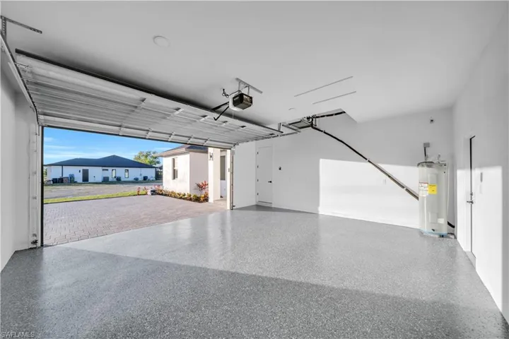 Garage with electric water heater and a garage door opener