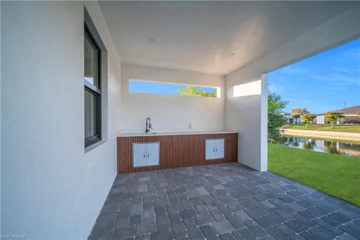 View of patio / terrace with a water view and a sink