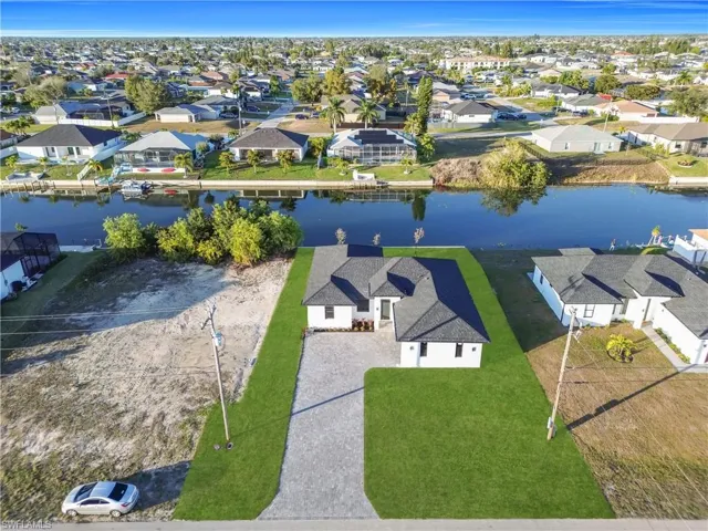 Aerial view of residential area featuring a nearby body of water