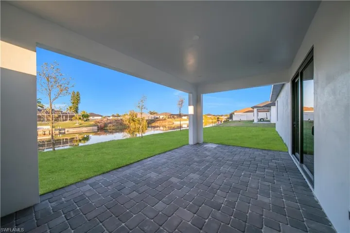 View of patio with a residential view and a water view