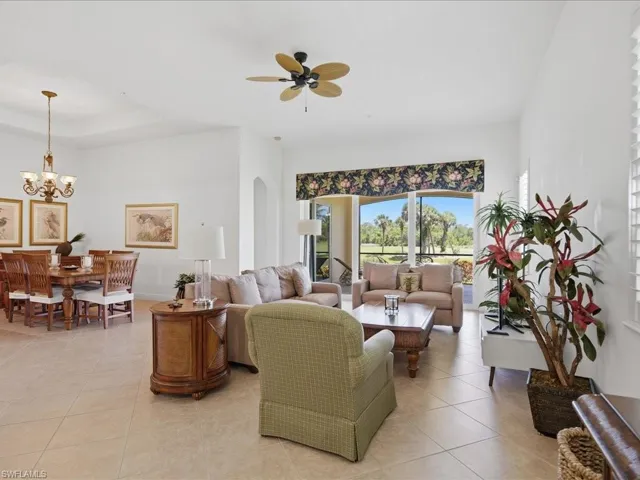 Expansive living area with large format tile flooring and high ceilings