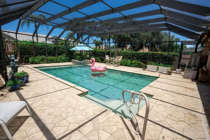 View of swimming pool with a patio and a lanai