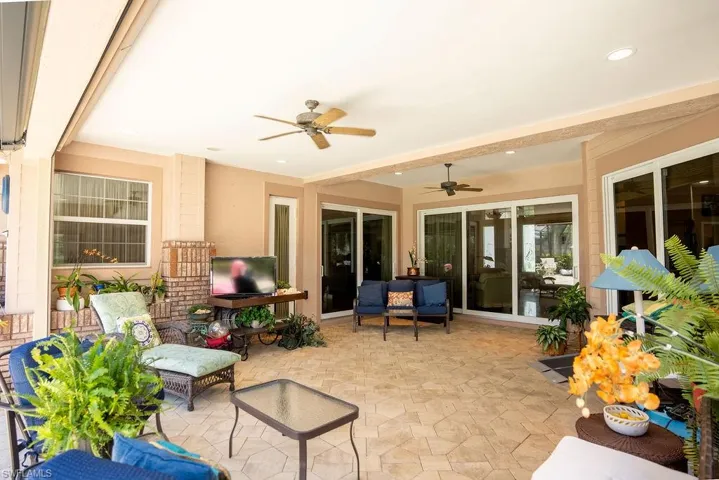 View of patio with ceiling fan and an outdoor living space