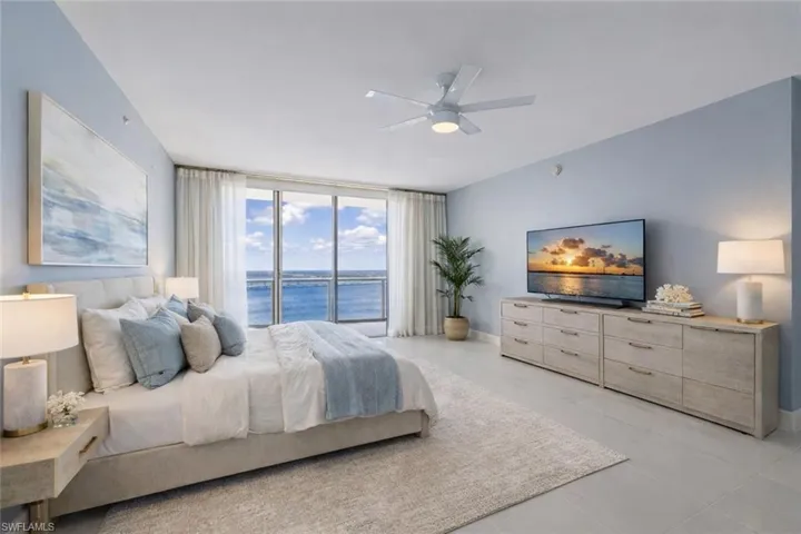 Bedroom virtually staged featuring floor to ceiling windows, a ceiling fan, and light tile patterned floors