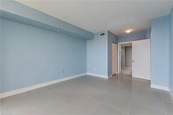 Empty room with baseboards and light tile patterned floors