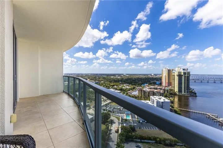 Balcony with a water view and a city view