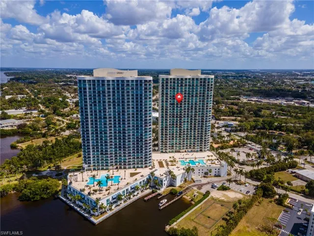 Drone / aerial view of a pool and a nearby body of water