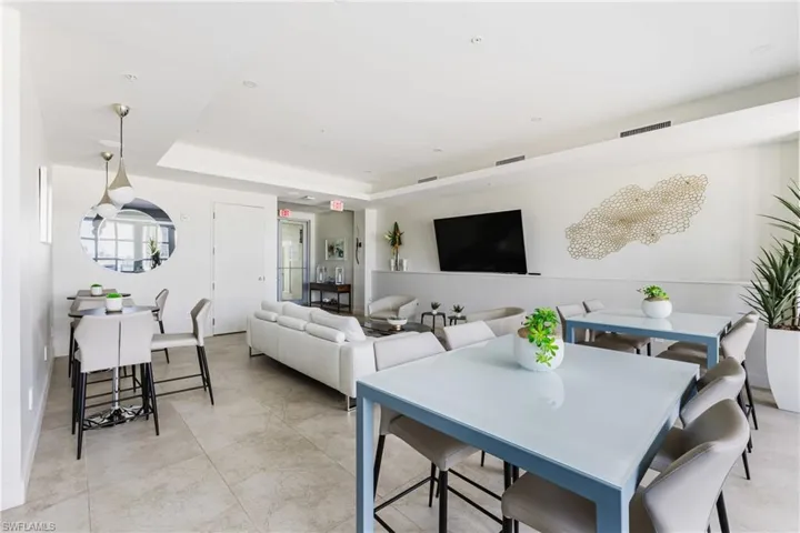 Dining space with a raised ceiling and recessed lighting