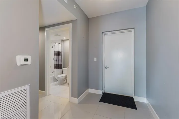 Foyer featuring baseboards and light tile patterned flooring