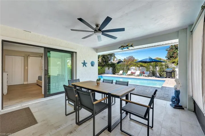 View of patio featuring an outdoor pool, outdoor dining space, a ceiling fan, and grilling area