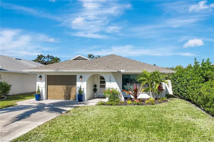 Single story home with a front yard, roof with shingles, stucco siding, and driveway