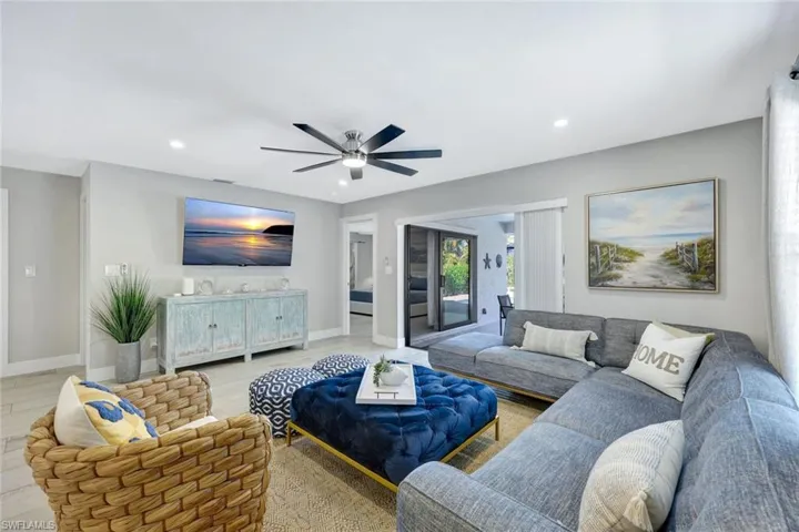Living area with a ceiling fan, wood finished floors, and recessed lighting