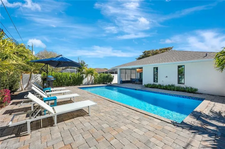 View of pool featuring patio surround and a sunroom