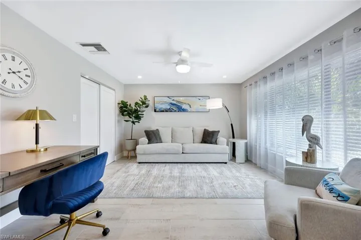 Living room with a ceiling fan and recessed lighting