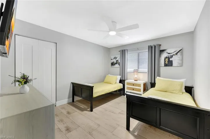 Bedroom featuring a closet, a ceiling fan, and light wood-type flooring