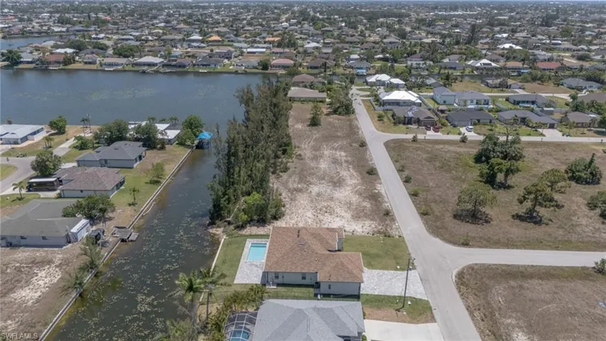 Aerial perspective of suburban area with a nearby body of water