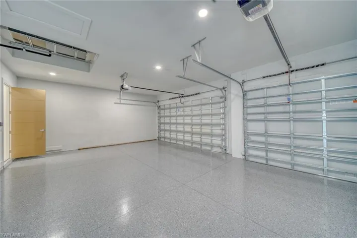 Garage with a garage door opener and recessed lighting