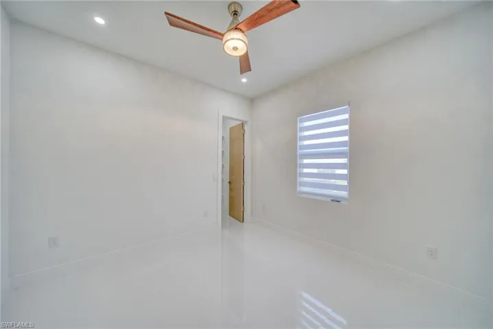 Empty room with ceiling fan and recessed lighting