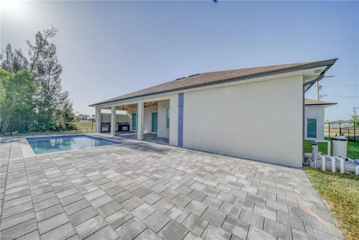View of pool featuring ceiling fan, a patio area, and fence