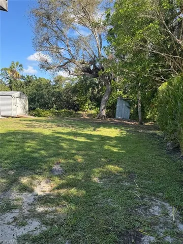 View of grassy yard with a shed