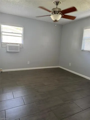 Spare room featuring a ceiling fan and a textured ceiling