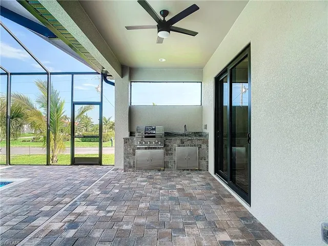 Unfurnished sunroom with ceiling fan
